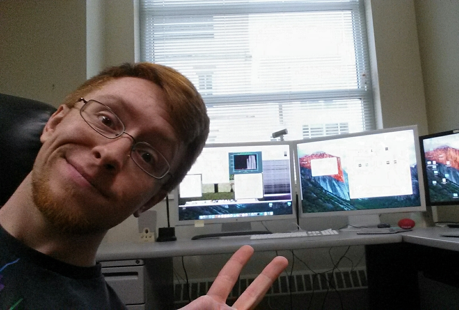 Selfie in front of remote observing setup during a run on the WIYN 3.5m